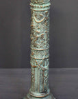 photo of plaster cast of ornamental verdigris color candlestick with gray background