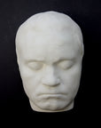 Photo of sculpture of life mask of Beethoven on a black background