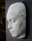 Photo of sculpture of life mask of Beethoven, side view, on a black background