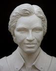 Photo of plaster cast of sculpture bust of Rosa Parks on a black background, closeup of face