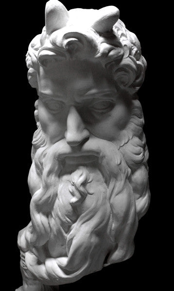 photo of plaster cast bust of man, namely Moses, with curly hair and so-called horns and long beard on black background