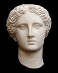 image of plaster cast sculpture mask of female, namely Athena, on a black background