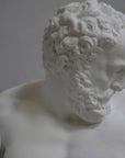 closeup photo of plaster cast of reclining male nude with a gray background