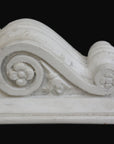photo with black background of plaster cast of architectural bracket with scroll design