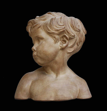 photo of plaster cast bust of boy on a black background