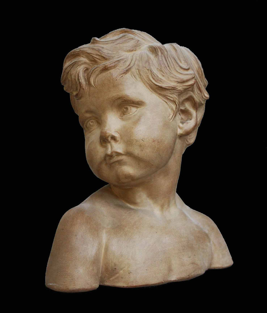 photo of plaster cast bust of boy on a black background