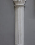 Photo of plaster cast sculpture of Greek half column on a grey background