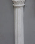 Photo of plaster cast sculpture of Greek half column on a grey background