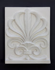 Photo of plaster cast of an Anthemion leaf palm design on a black background