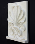 Photo of plaster cast of an Anthemion leaf palm design, 3/4 view, on a black background