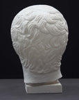 photo of plaster cast sculpture of head of the Doryphoros, male with curly hair, on dark gray background