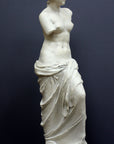 Photo of plaster cast sculpture reproduction of Venus de Melo on a grey background