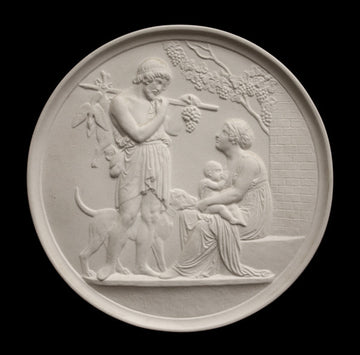 photo of off-white plaster cast relief sculpture of female figure with baby on lap, a standing male figure, and a dog against black background