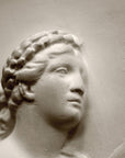 photo closeup of plaster cast sculpture relief of man's head, namely the god Apollo
