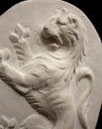 Photo with black background of plaster cast sculpture relief of lion on hind legs