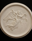 photo of plaster cast relief of female with wings flying and a cherub on her back on black background