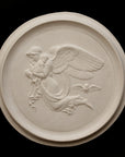 photo of plaster cast relief of woman with wings flying with two children nestled against her and an owl flying on a dark background