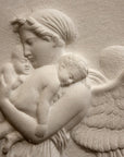 detail photo of plaster cast relief of woman with wings flying with two children nestled against her and an owl flying on a dark background