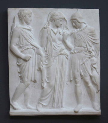 photo with gray background of plaster cast of ancient relief with three figures, namely Hades, Eurydice, and Orpheus
