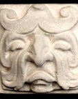 Photo of square tile sculpture of sad face made of leaves