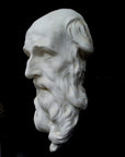 photo with black background of plaster cast of the male face of Saint Andrew with long beard