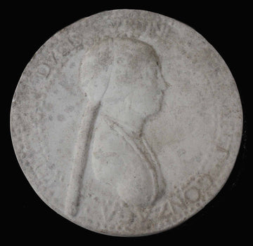 photo of plaster cast of small medallion with female portrait profile on black background