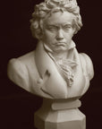 photo of plaster cast sculpture of male bust of Ludwig van Beethoven in dress coat and ruffled necktie on black background
