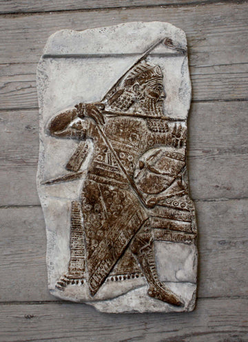 Photo of plaster cast sculpture of ancient sculpture relief on a wooden wall