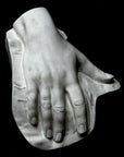 Photo of a plaster hand on a black background