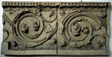 photo of plaster cast of architectural ornament with scroll and leaves against white background