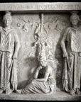 black and white photo of plaster cast of free-standing relief sculpture with three female figures, two of which are caryatides, on black background