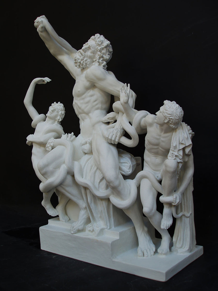 photo with black background of plaster cast sculpture of partially nude male figure, namely Laocoon, and two nude young men being attacked by serpents which twist in and out of the three figures