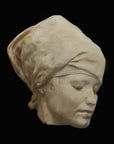 Photo of plaster cast of Nubian Female Mask on a black background