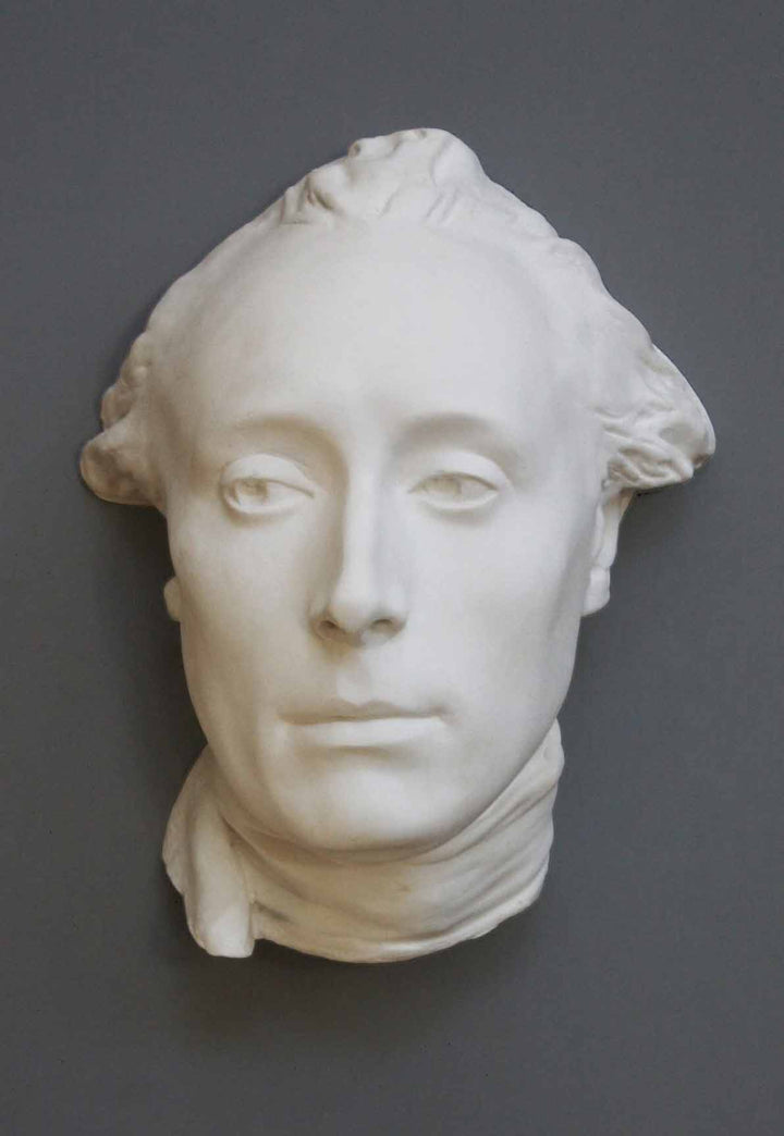 photo with gray background of plaster cast of male head with neckerchief