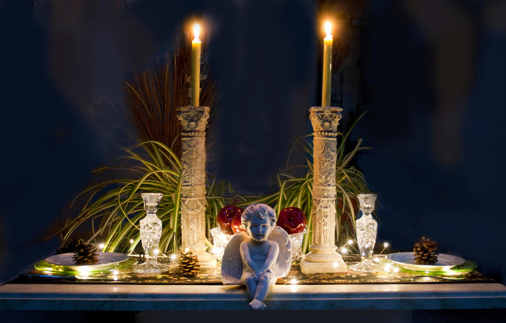 Photo of several Caproni casts displayed together on a table with lit candles