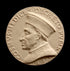 photo of off-white plaster cast relief sculpture of small medallion of male portrait in profile, namely Cosimo de Medici, and text around the edge on black background