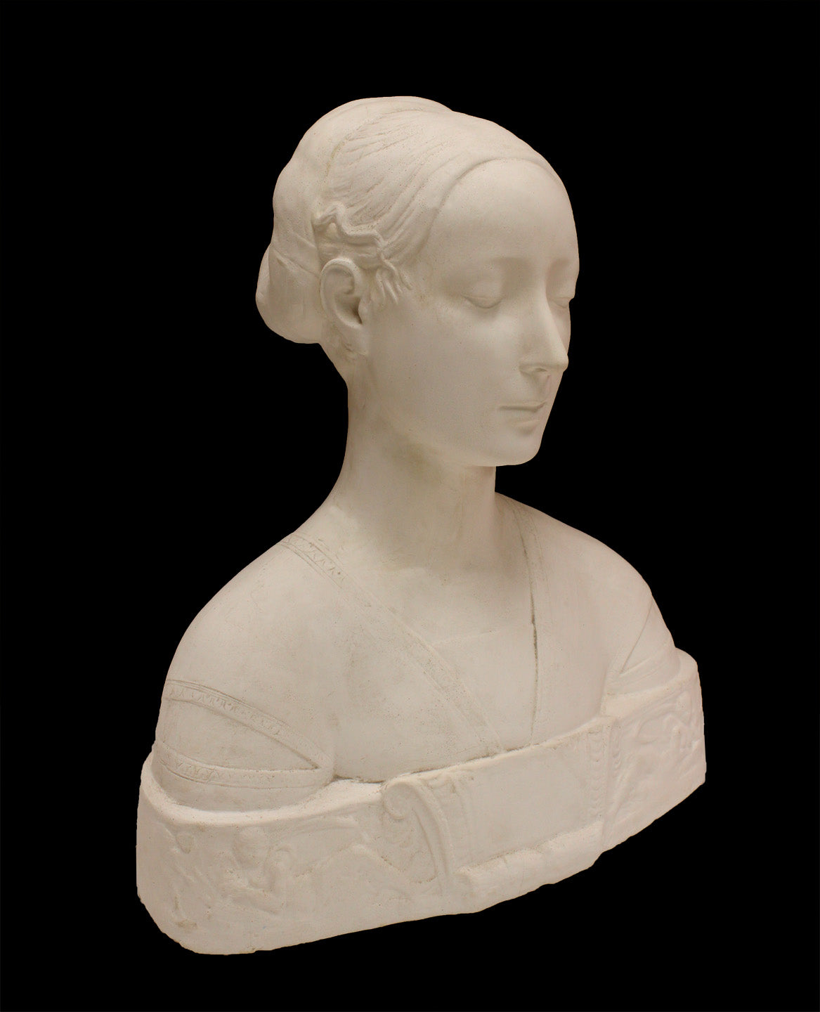photo of white plaster cast sculpture of female bust cropped at shoulders with decorative base against black background