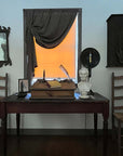 plaster cast bust sculpture of man with beard, namely Lincoln, on antique wooden table decorated with antique books, candles, and other paraphernalia and two wood and wicker chairs beside the table and sunlight coming in shaded window behind