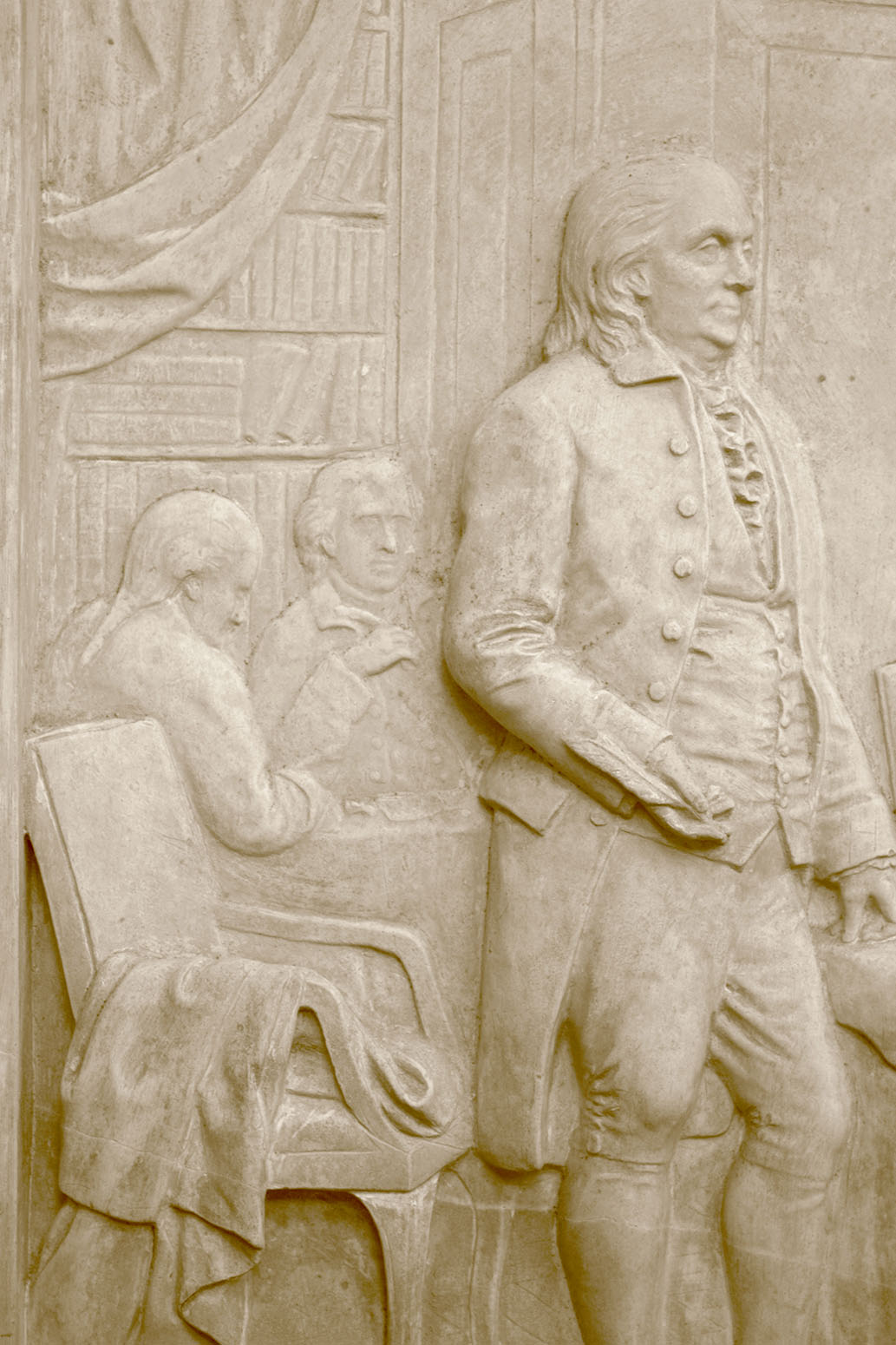 detail photo of off-white plaster cast relief sculpture of four men around a table aka signing the Treaty of Peace and Independence