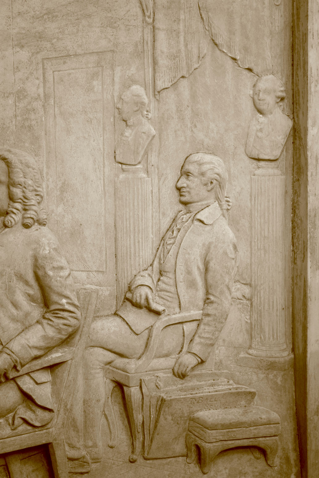 detail photo of off-white plaster cast relief sculpture of four men around a table aka signing the Treaty of Peace and Independence