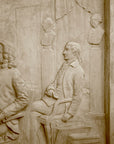 detail photo of off-white plaster cast relief sculpture of four men around a table aka signing the Treaty of Peace and Independence