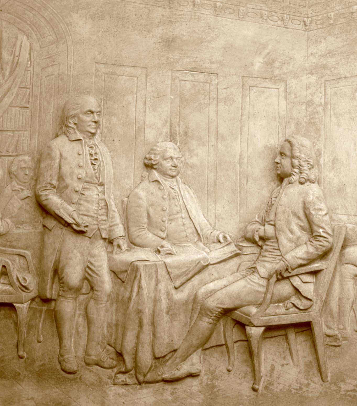 detail photo of off-white plaster cast relief sculpture of four men around a table aka signing the Treaty of Peace and Independence