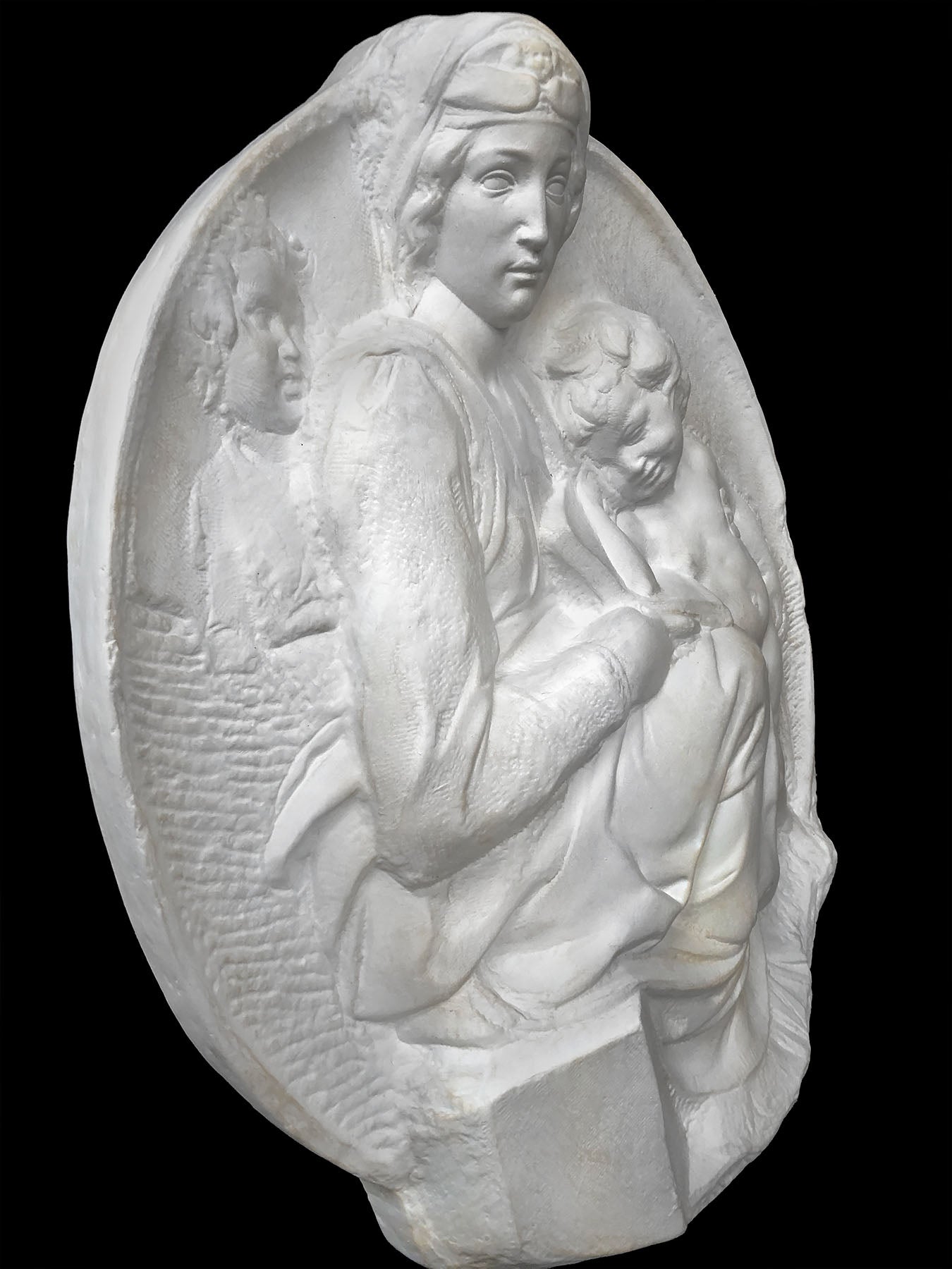 image of a plaster statue of a bust of madonna and child on a black background