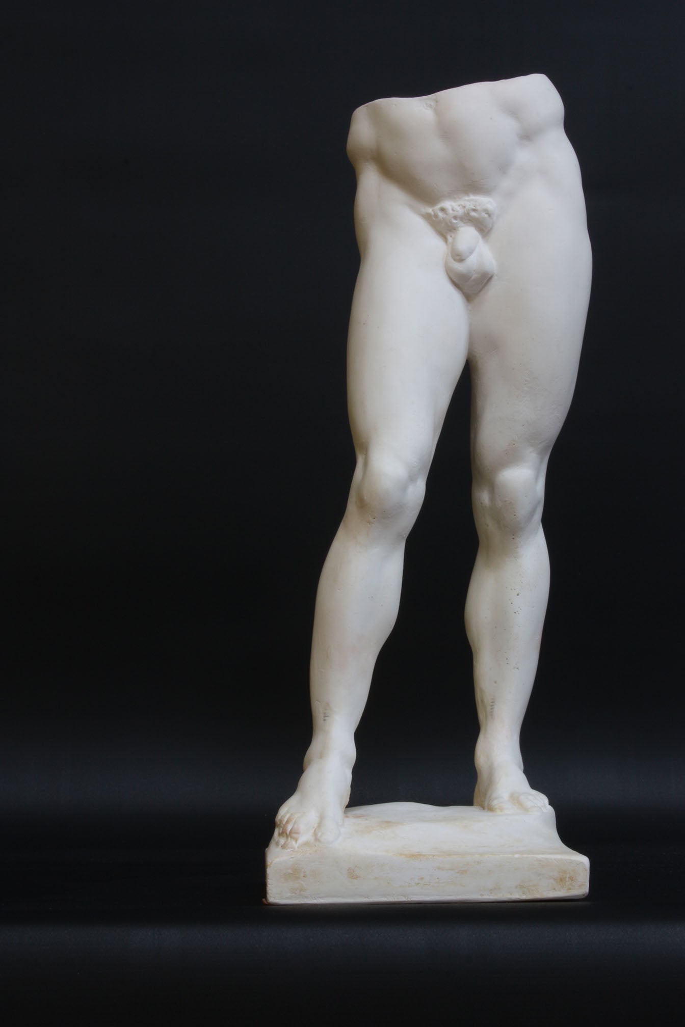 Photo of a decorative sculpture of a man's torso on a black background