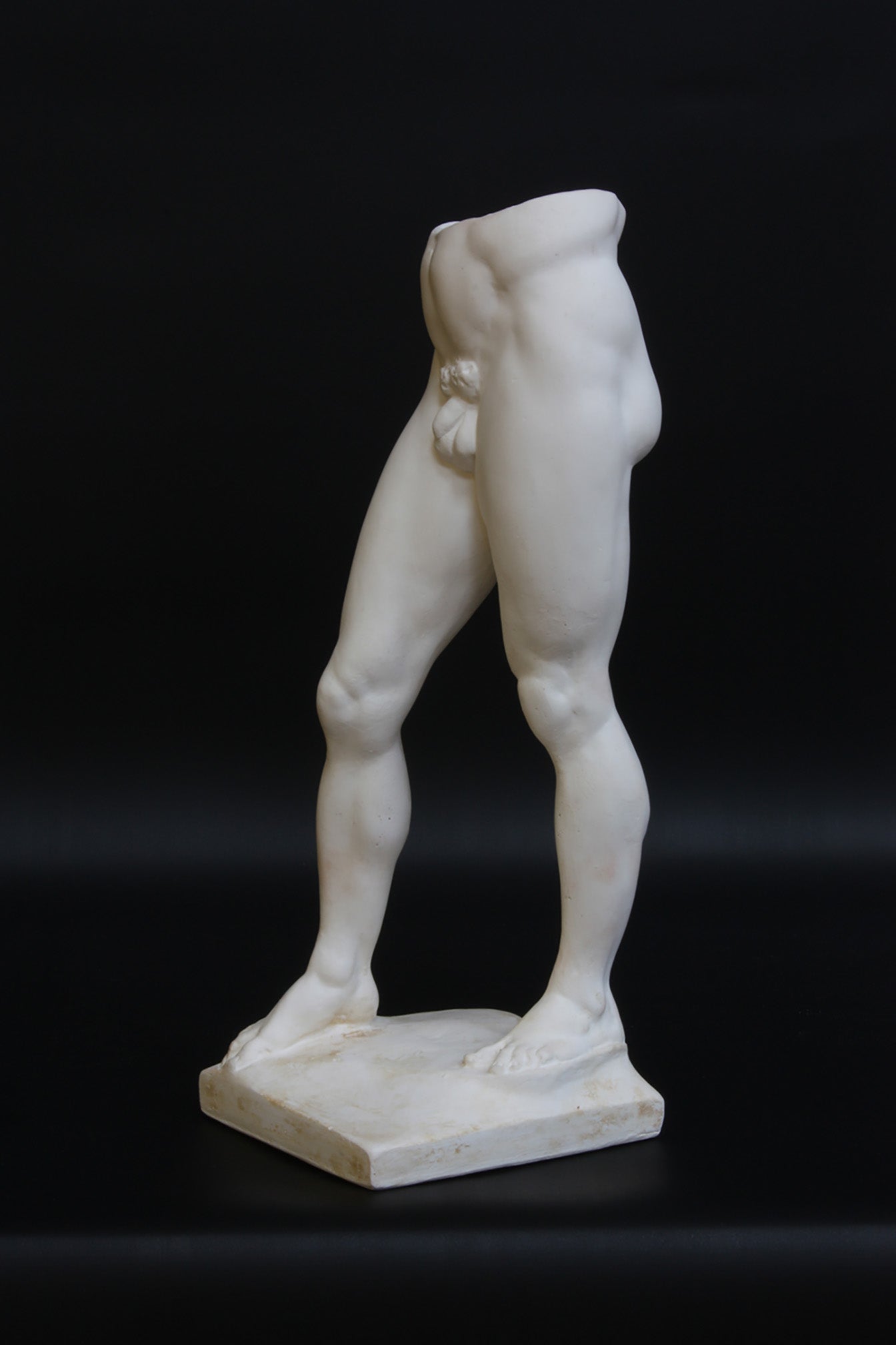 Photo of a decorative sculpture of a man's torso on a black background