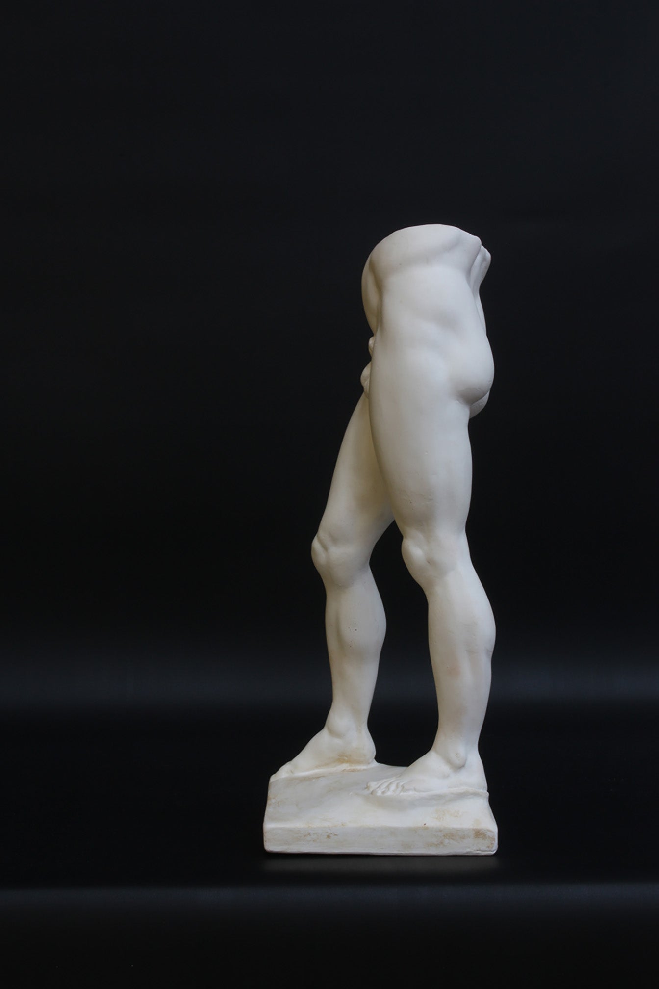 Photo of a decorative sculpture of a man's torso on a black background