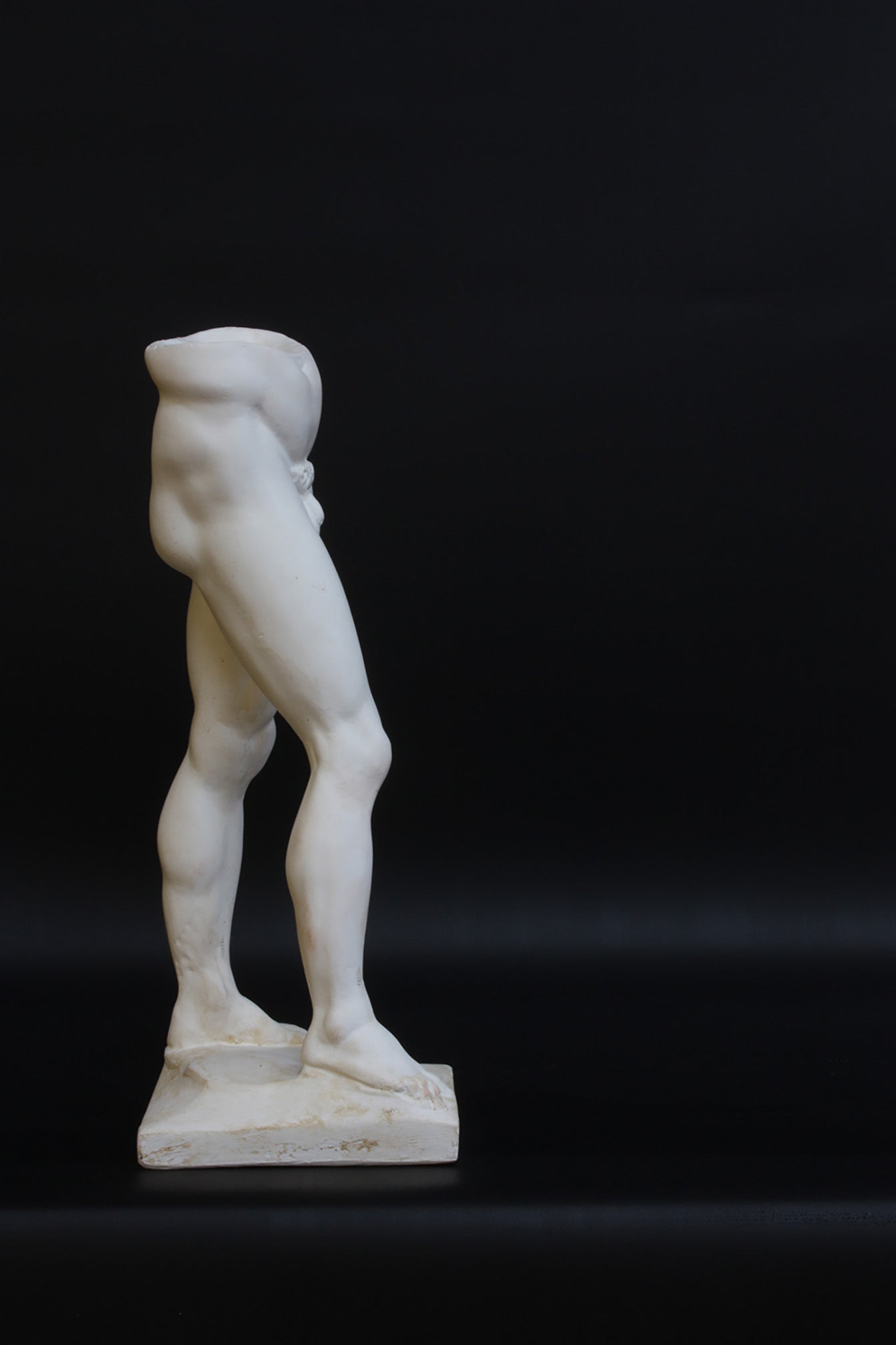 Photo of a decorative sculpture of a man's torso on a black background