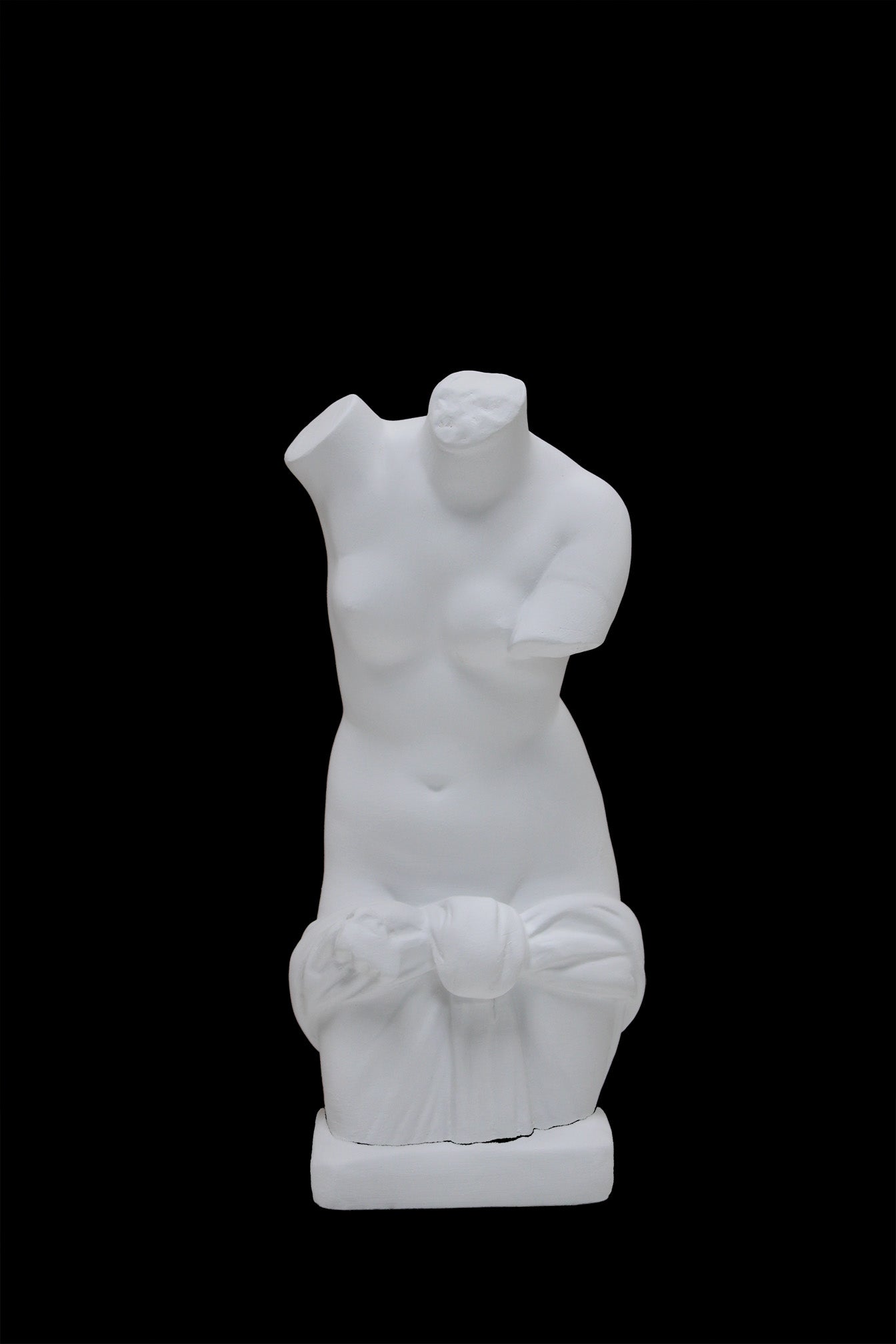 Photo of a sculpture of a ladies torso on a black background 