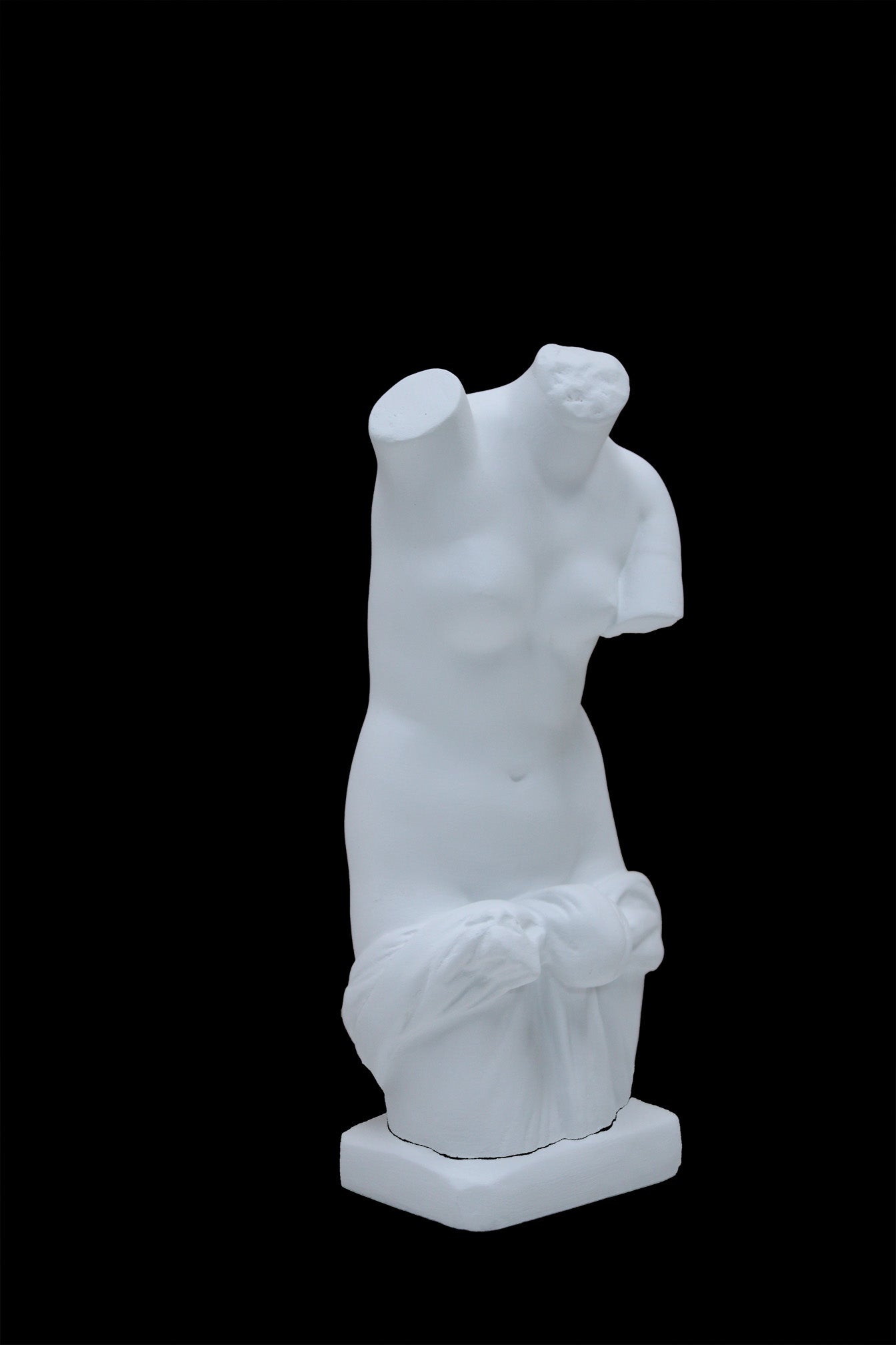 Photo of a sculpture of a ladies torso on a black background 
