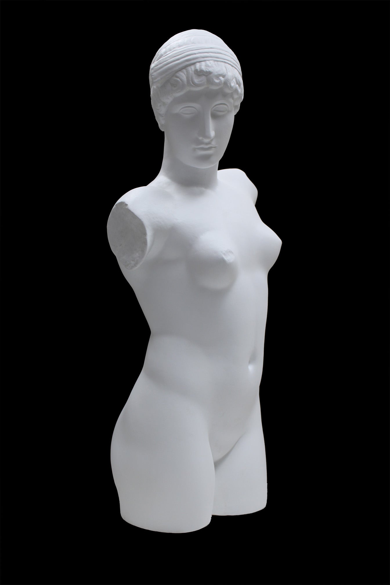 Photo of a sculpture of a female torso with a head